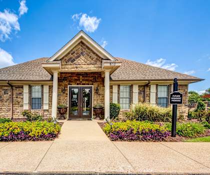 the front of a brick house with a welcoming front door