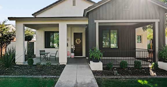 A modern house with a front porch and a covered entryway.