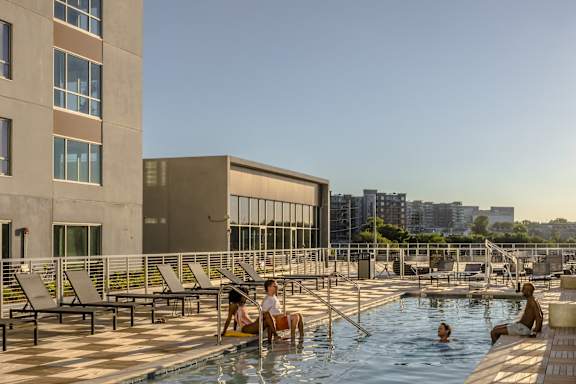people in a swimming pool on the roof of a building at South Falls Tower, Richmond, VA, 23224