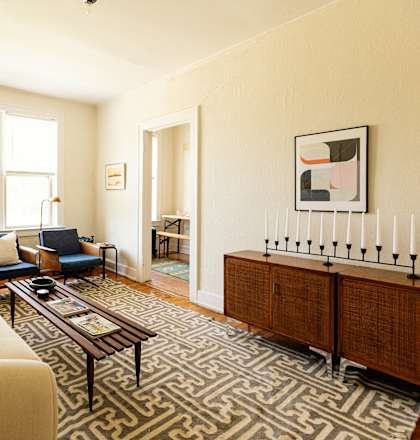 a living room with a couch and a rug