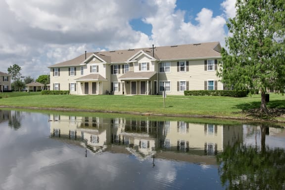 a large pond sits in front of a large house