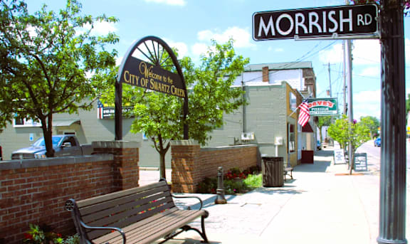 A sign for the City of Sharkey is displayed on a street corner.
