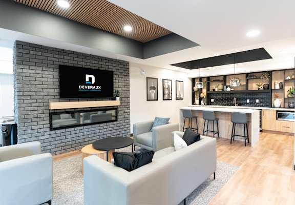 A modern living room with a brick fireplace and a television displaying the word "DEVERAUX".