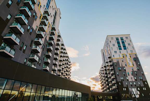two tall buildings with the sky in the background