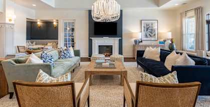 a living room with couches and chairs and a fireplace