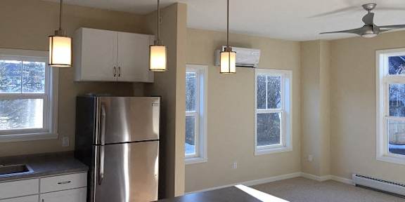 a kitchen with a refrigerator freezer next to a window