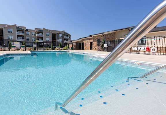A swimming pool with a metal railing.