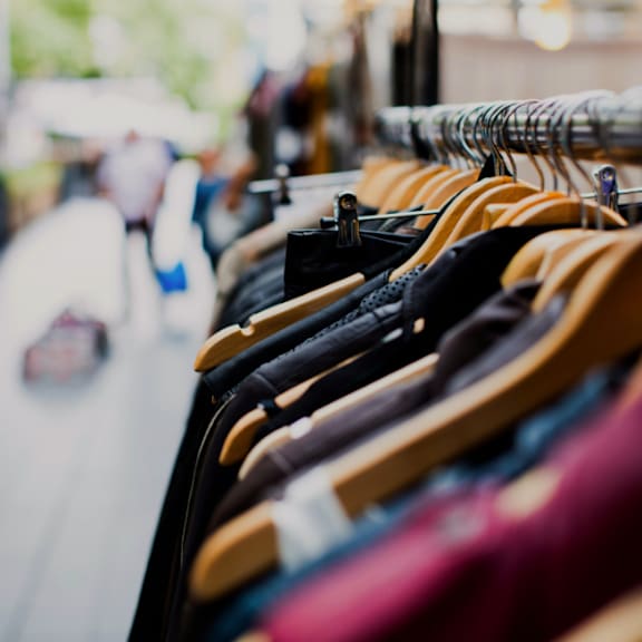 a row of clothes on display on a street