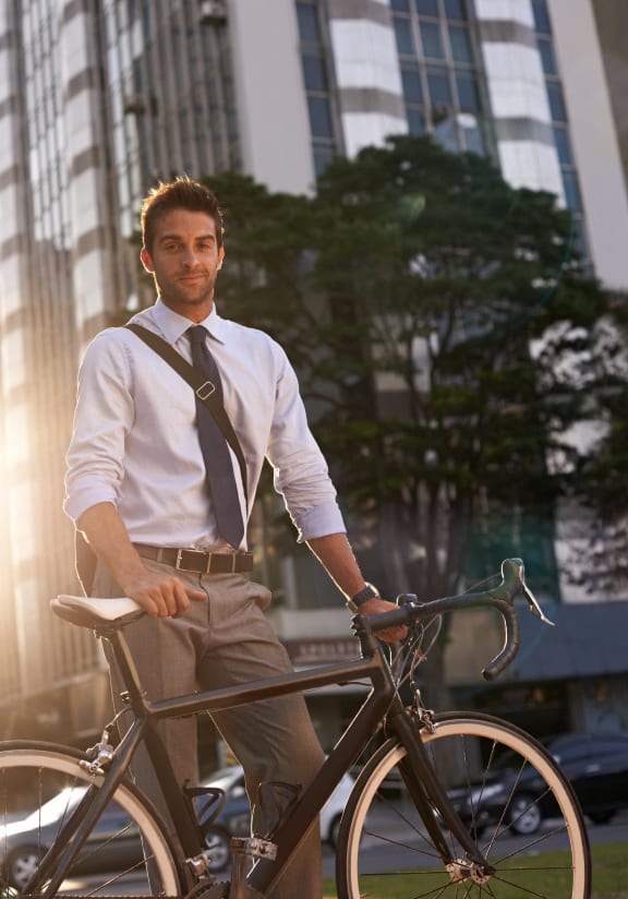 a man standing with a bike in the city