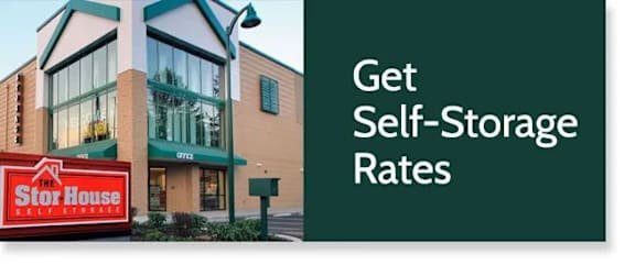 A sign advertising self-storage rates in front of a building.