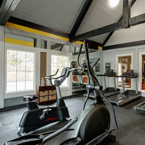 the gym with cardio equipment and weights at The Grove Brentwood in Nashville, TN