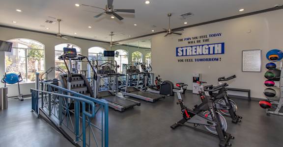 A gym with a sign that says "The pain you feel today will be the strength you feel tomorrow!"