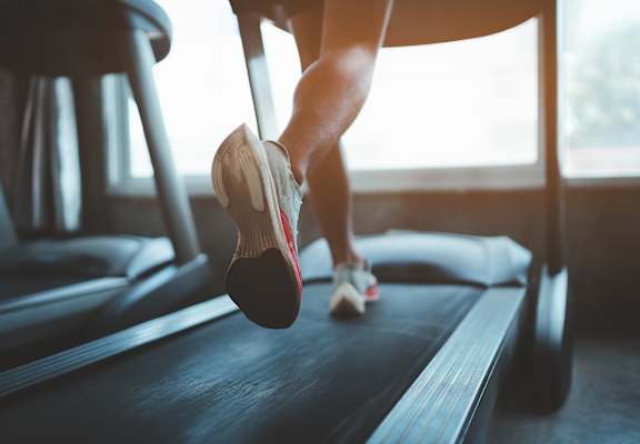 Lifestyle photo of a person running on the treadmill
