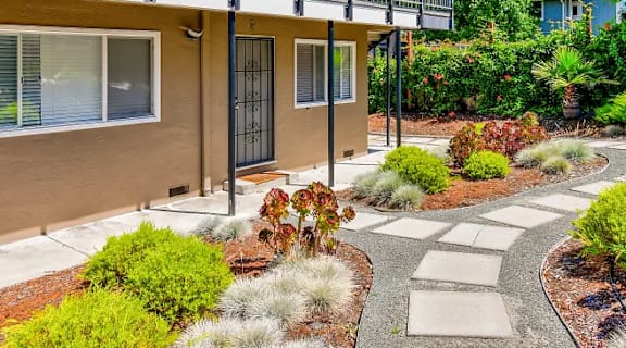a house with a balcony and a walkway in front of it