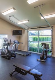 a gym with exercise equipment and a window