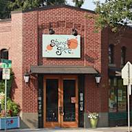 A brick building with a sign that says Staccato Gelato.