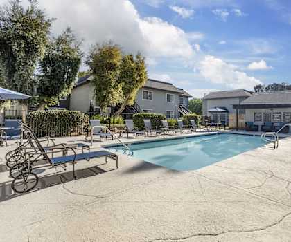 our apartments have a resort style pool with lounge chairs and umbrellas