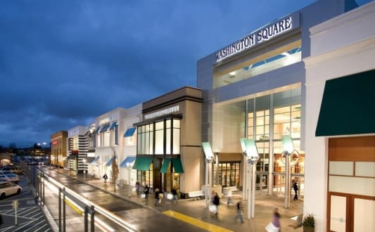 a rendering of a shopping center with people walking in front of it