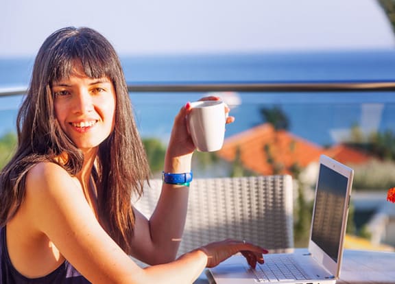 Woman working on laptop at Alhambra Cove, Miami, 33167