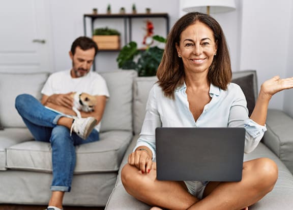 Couple at home on couch with dog  at Bonita Pointe, Florida, 33034
