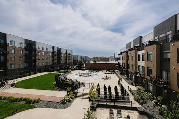 A view of a courtyard with a pool and apartment buildings.