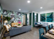 Thumbnail 1 of 19 - a living and dining area with a blue couch and green chairs