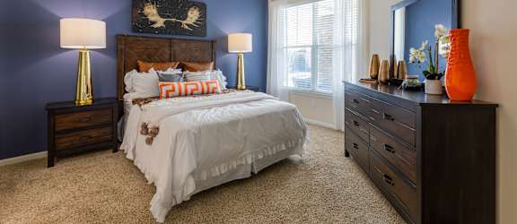 a bedroom with a bed and a ceiling fan