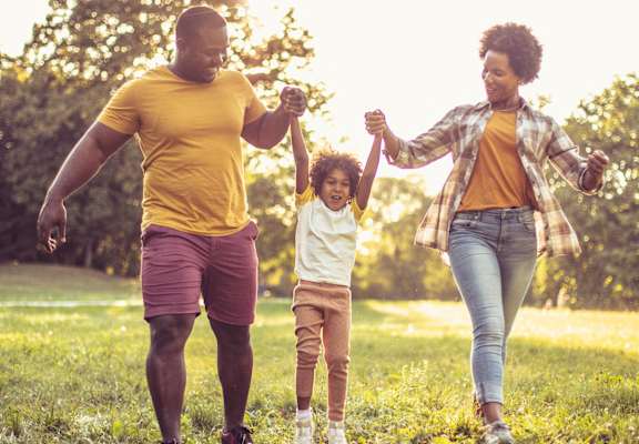 happy family walking in the park free photo