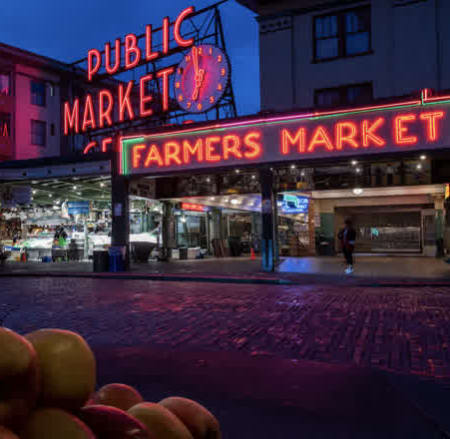 the public market farmers market on a city street at night