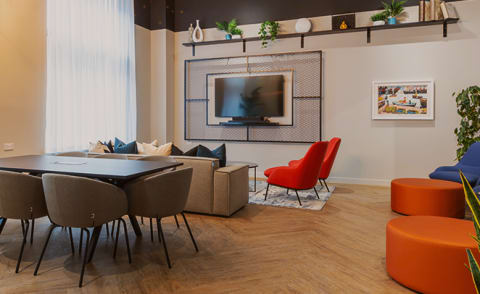 a living room with a tv and a table and chairs