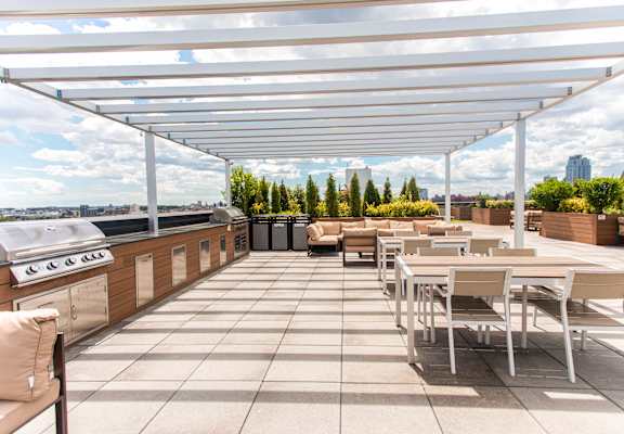 A patio with a table and chairs under a white canopy.