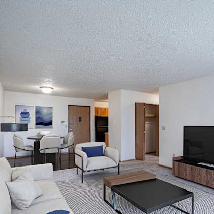 a living room with a couch and a coffee table and a television. Fargo, ND Prairie Park Apartments