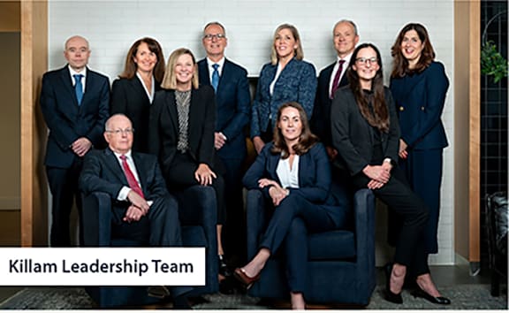 A group of executives standing together for a group picture