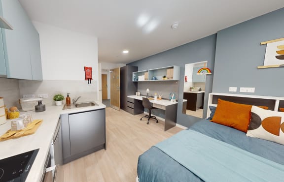 a bedroom with a bed and a desk with a chair