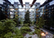 Thumbnail 1 of 9 - a courtyard filled with trees and a fire pit
