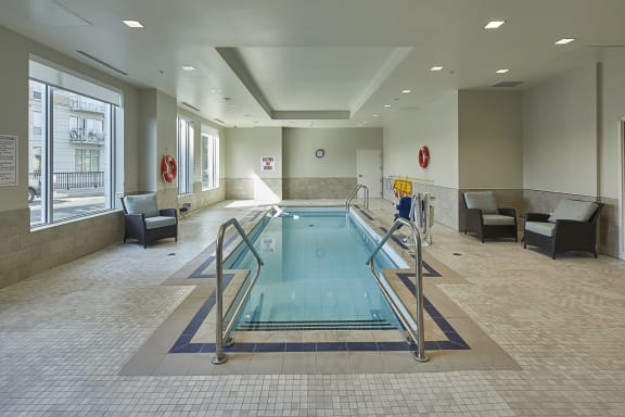 A swimming pool room with seating.
