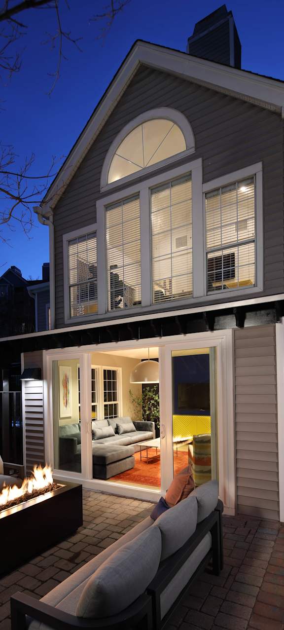 A house with a lit fireplace on the patio.