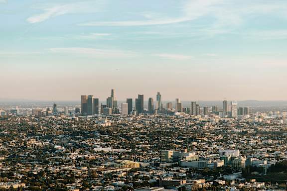 A cityscape with a hazy skyline of tall buildings.