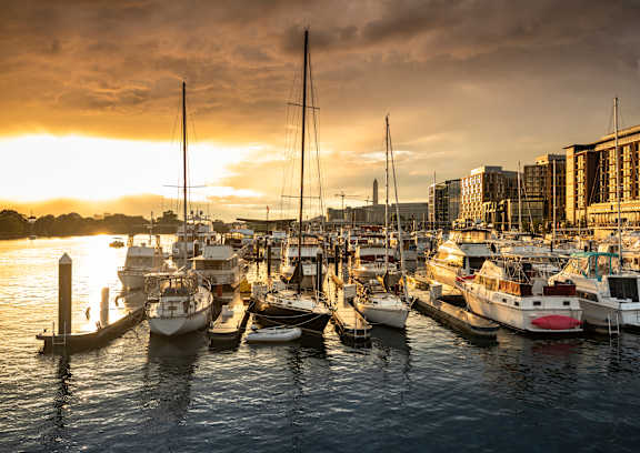 A marina filled with boats at sunset.