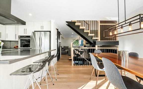 a kitchen and dining room with a table and chairs