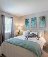 a bedroom with a bed and a nightstand and a window at Courthouse Green Apartments, Chesterfield