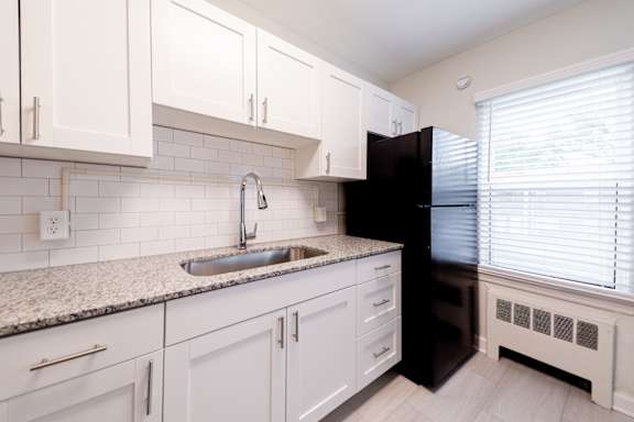 a kitchen with white appliances and wooden cabinets