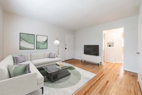 a living room with wood floors and a large window