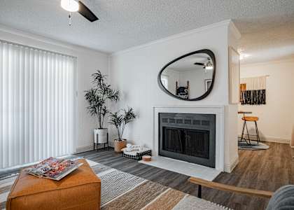 a living room with a fireplace and a mirror