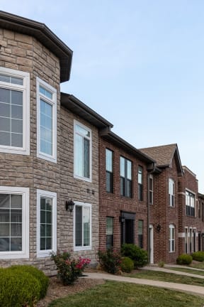 a brick building with a sidewalk in front of it