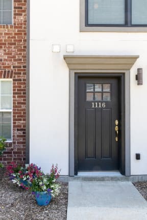 a black door with the number 1116 on it