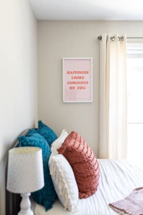 a bedroom with a bed and a lamp