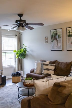 a living room with a couch and a ceiling fan