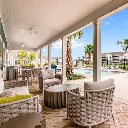 A patio with a table and chairs at Watermark at Urban Blu, Florida, 32407