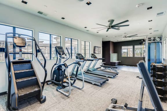 a gym with cardio equipment and windows in a building at Grandstone at Sunrise, Peoria, AZ, 85383